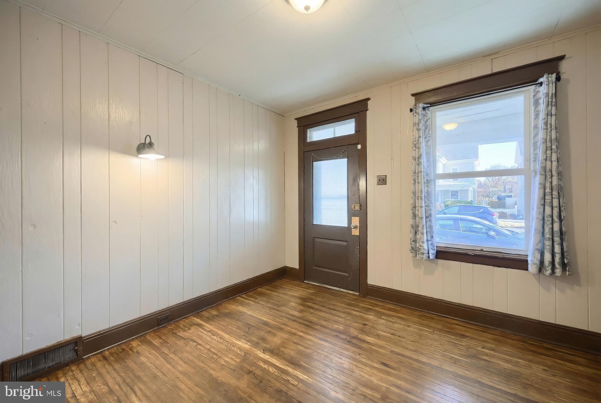 52 South Third Street Mount Wolf, PA 17347 - Photo 12 of 28 an empty room with wooden floor and windows