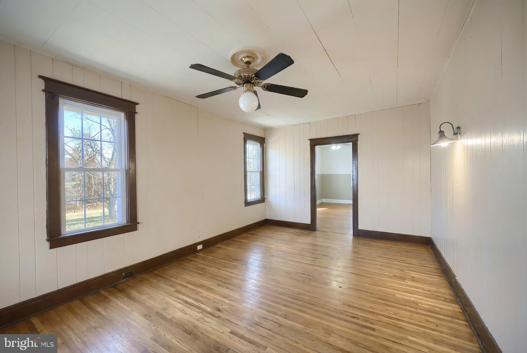 52 South Third Street Mount Wolf, PA 17347 - Photo 13 of 28 a view of an empty room with window and wooden floor