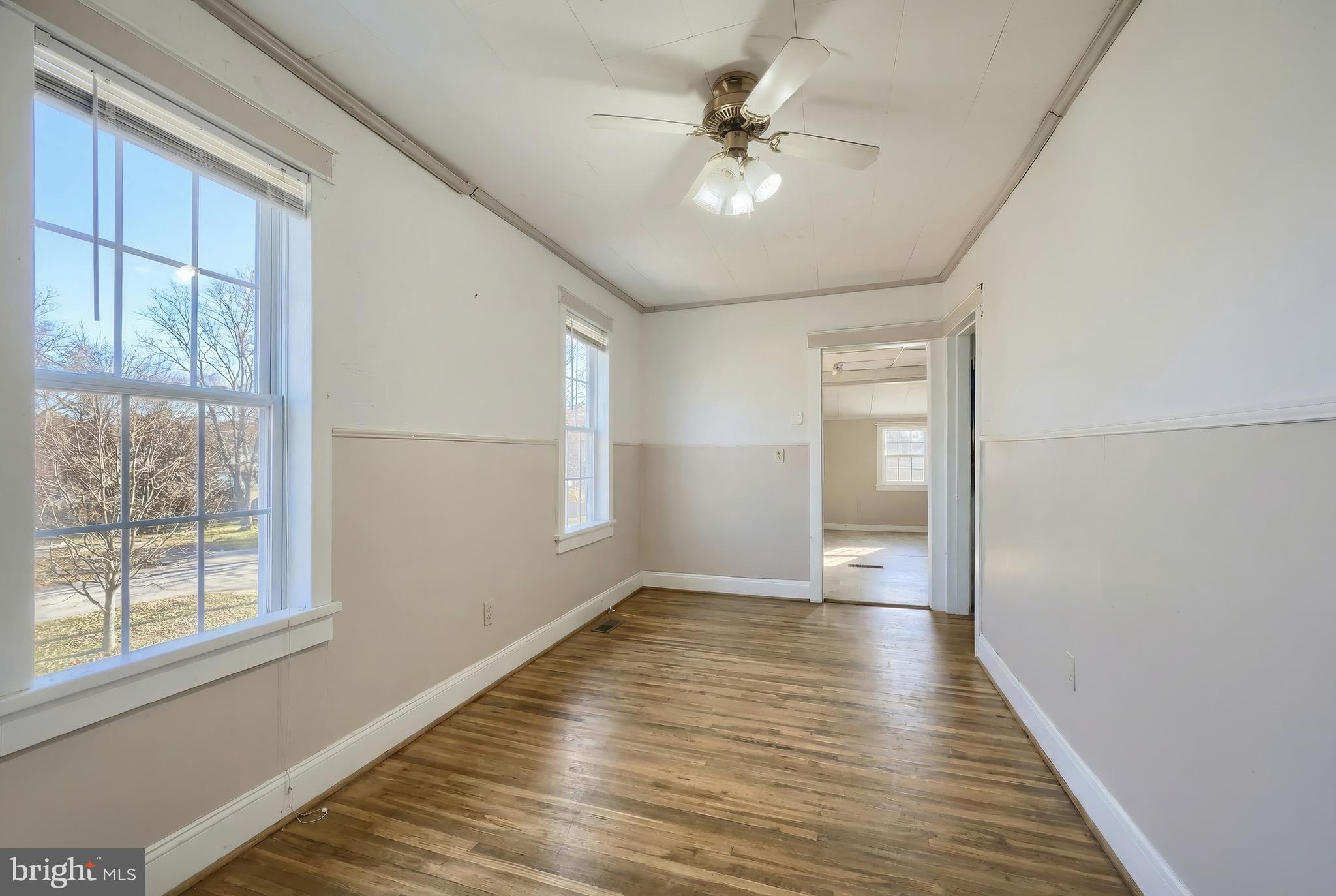 52 South Third Street Mount Wolf, PA 17347 - Photo 14 of 28 a view of an empty room with a window and wooden floor