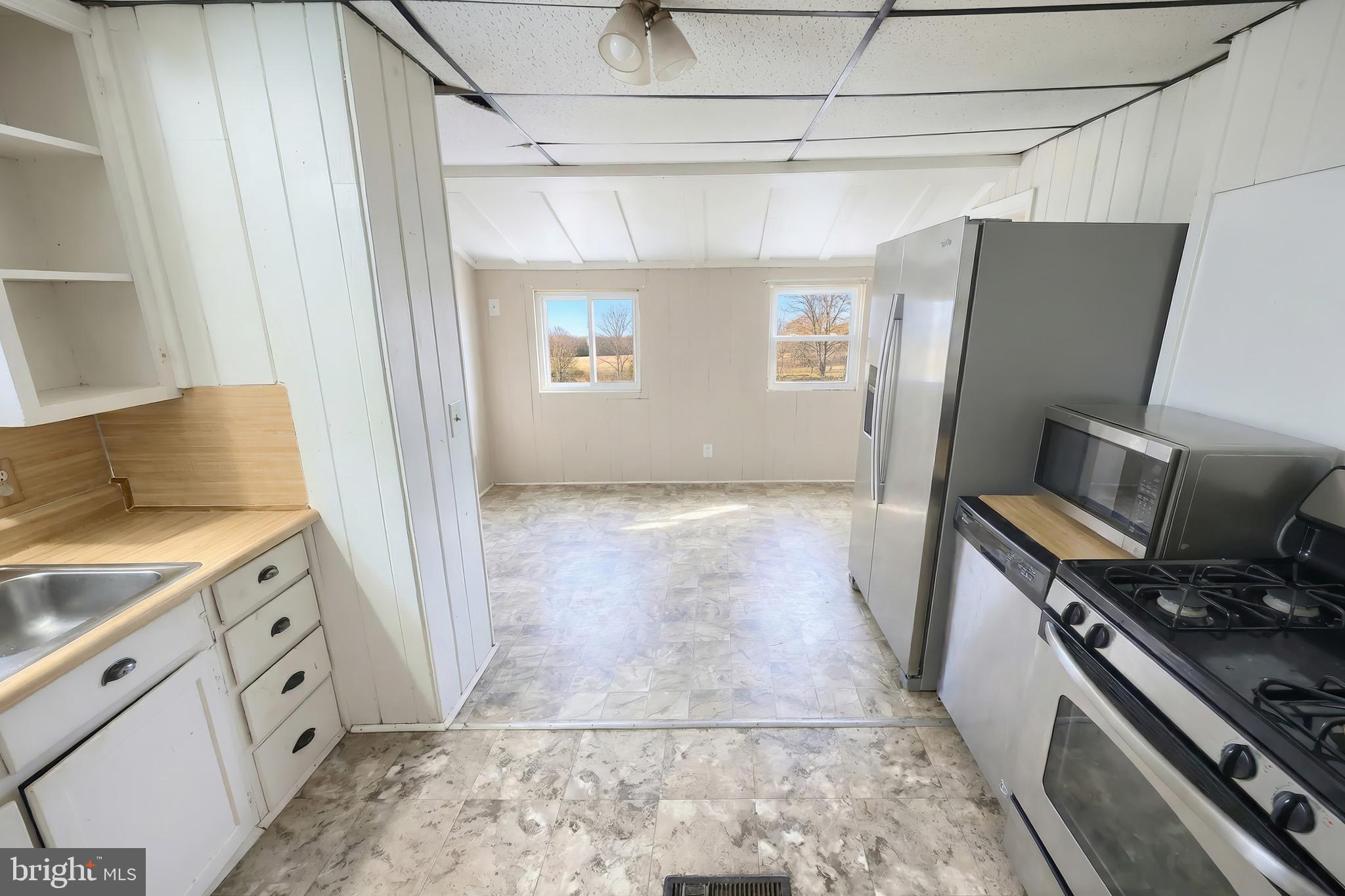 52 South Third Street Mount Wolf, PA 17347 - Photo 16 of 28 a view of a kitchen with fridge and wooden floor