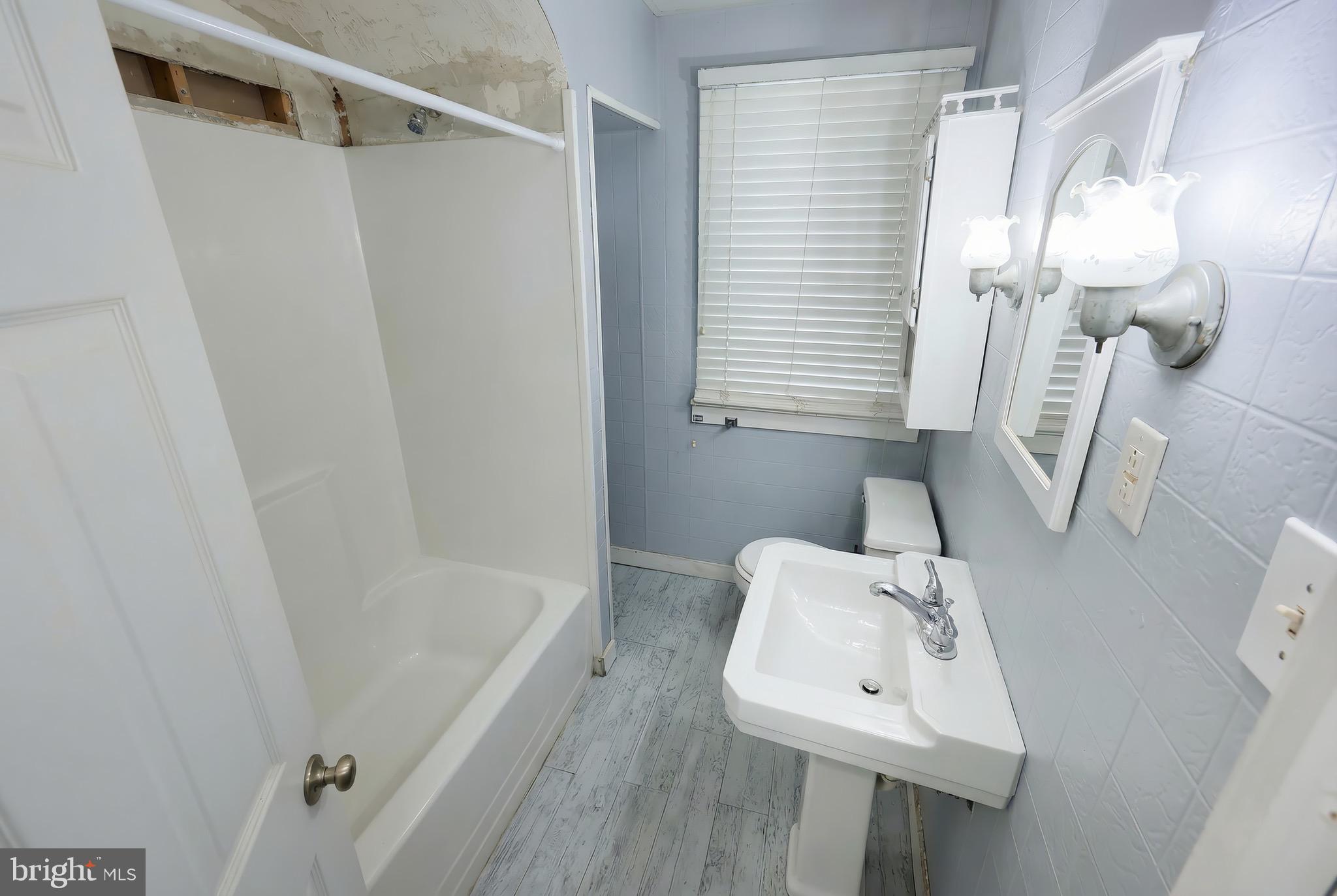 52 South Third Street Mount Wolf, PA 17347 - Photo 18 of 28 a bathroom with a sink a toilet and shower