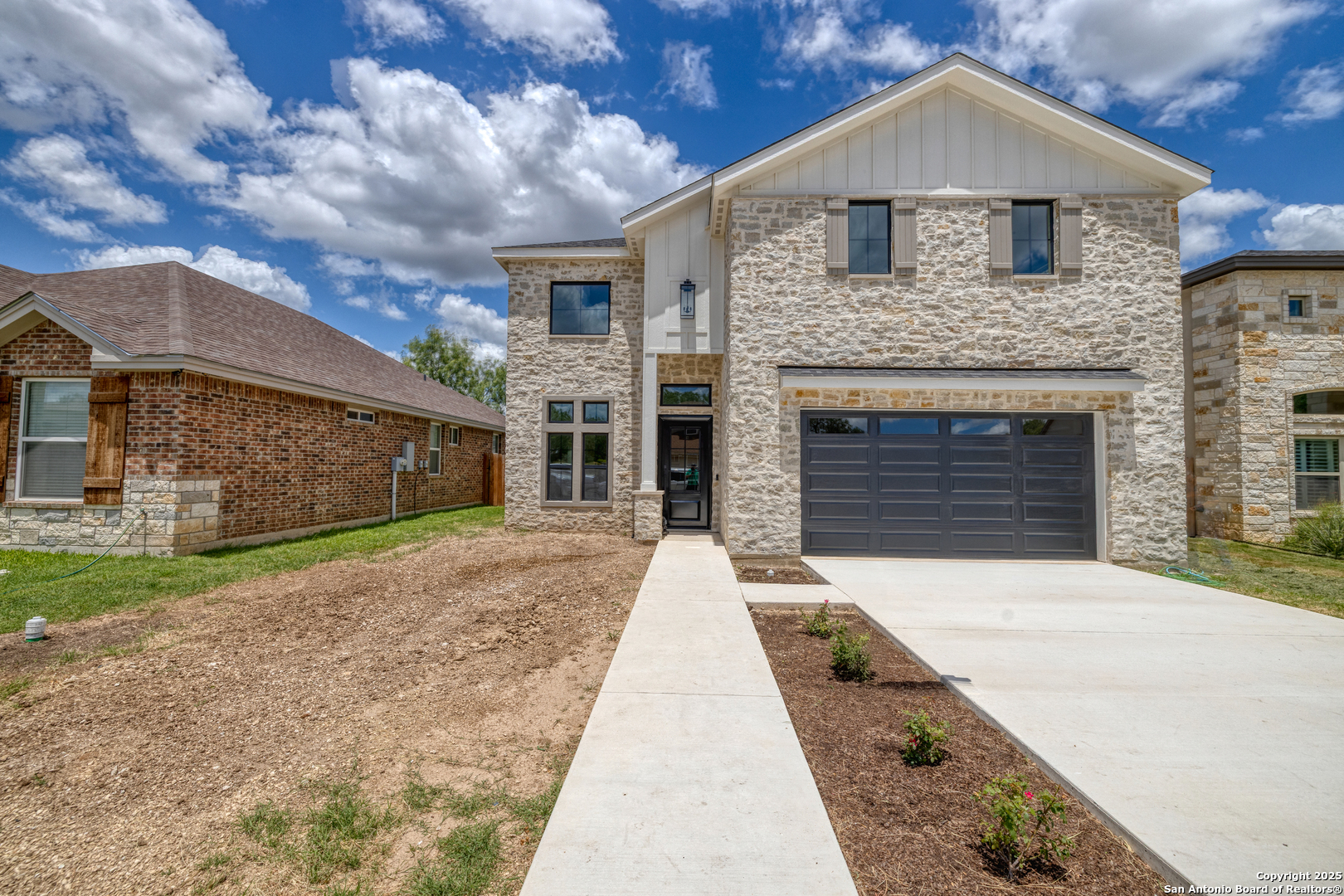 a front view of a house with a yard and garage