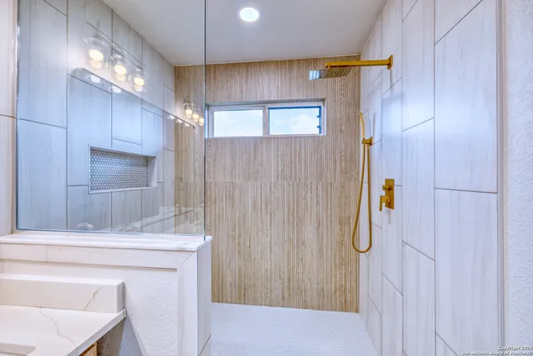 a bathroom with a shower and a mirror
