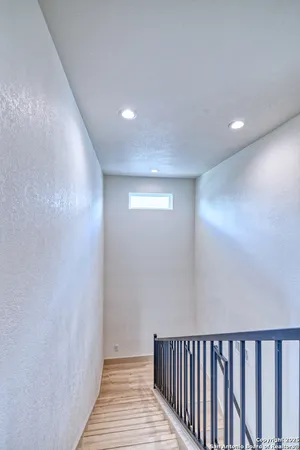 a view of hallway with wooden floor
