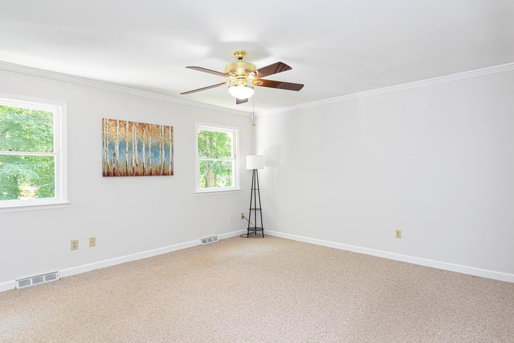 509 Compton Road Raleigh, NC 27609 - Photo 12 of 30 Primary Bedroom with ceiling fan, crown molding, and double windows. Primary Bedroom