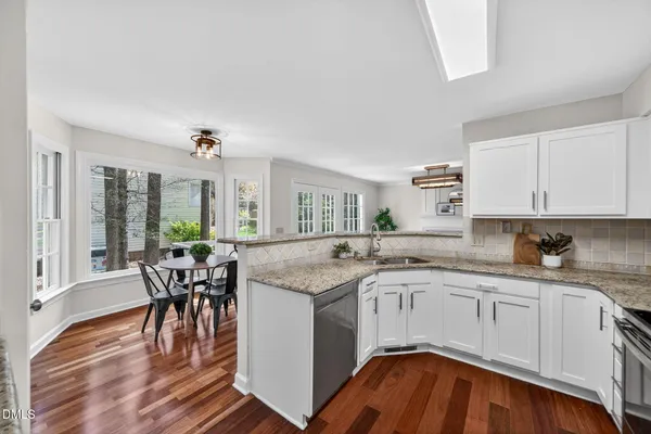 a kitchen with granite countertop a sink and cabinets