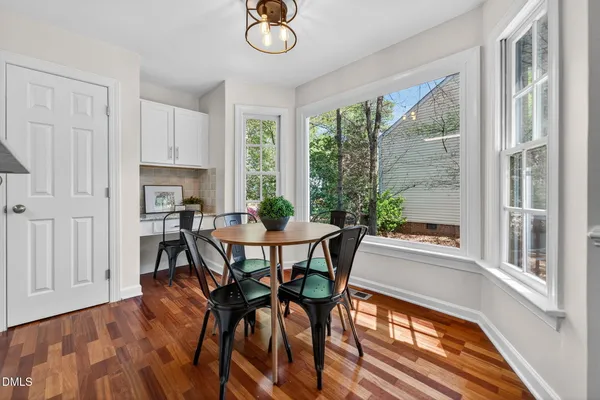 a view of a dining room with furniture window and wooden floor