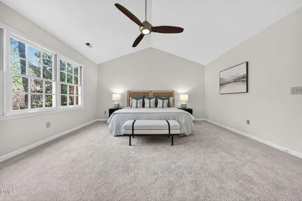 a spacious bedroom with a bed and a window