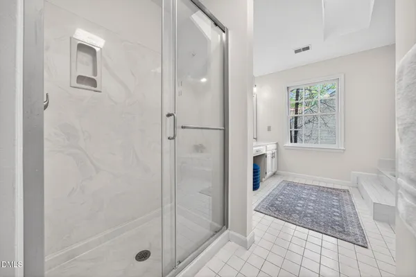 a spacious bedroom with a bed and a table