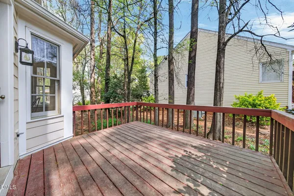 a view of balcony with wooden floor and fence