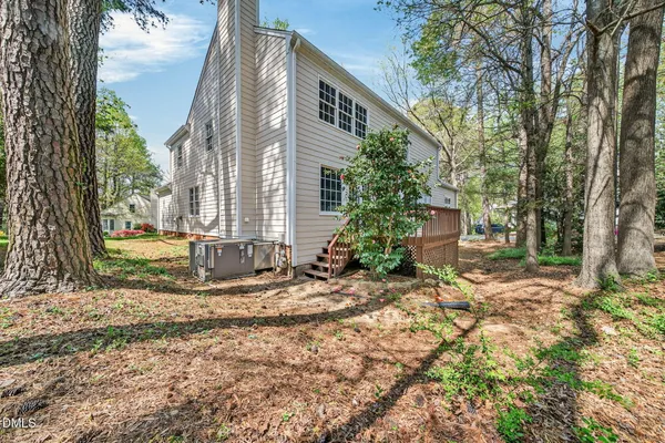 a view of a house with a yard and tree