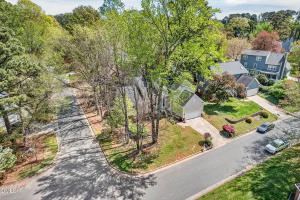 an aerial view of a house with a yard