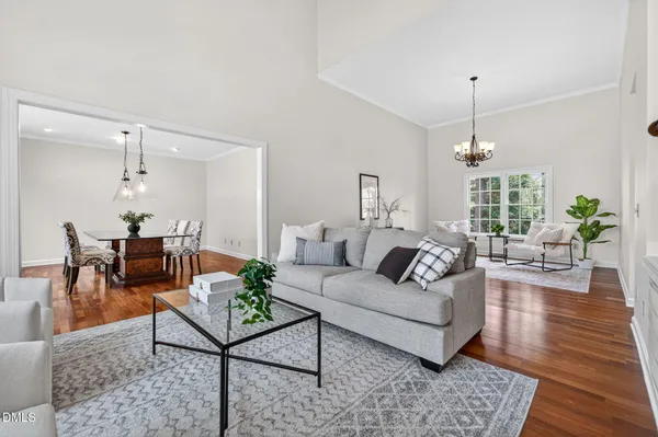 a living room with furniture and a chandelier