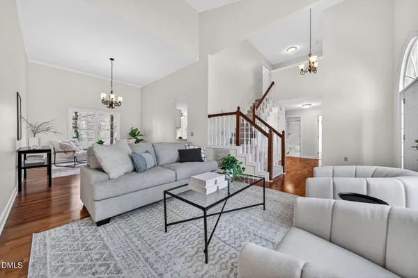 a living room with furniture and a chandelier
