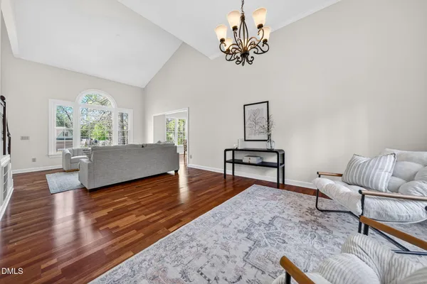 a living room with furniture and a chandelier