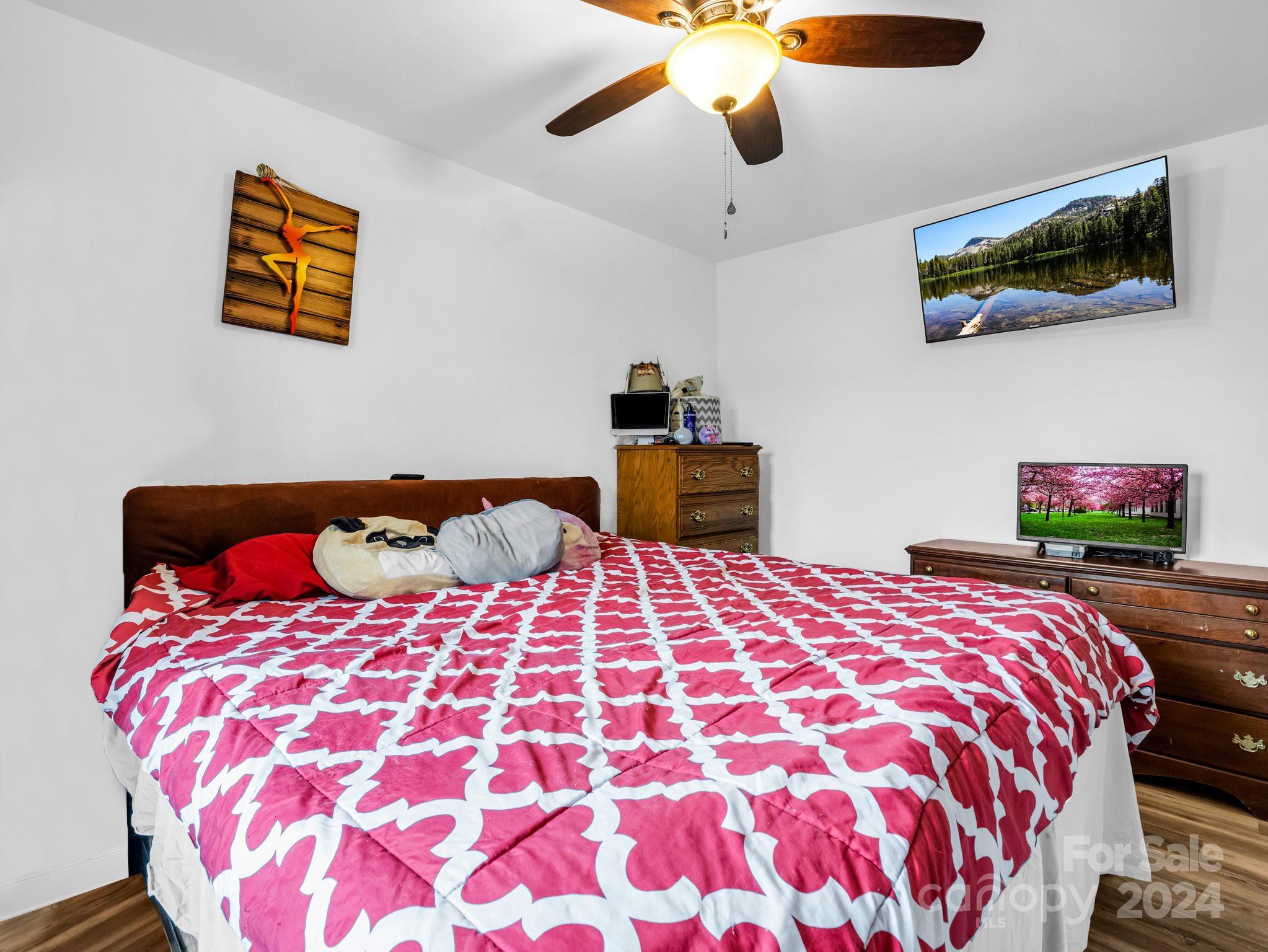 1251 Howards Creek Mill Road Vale, NC 28168 - Photo 11 of 30 a bedroom with a bed and a flat screen tv