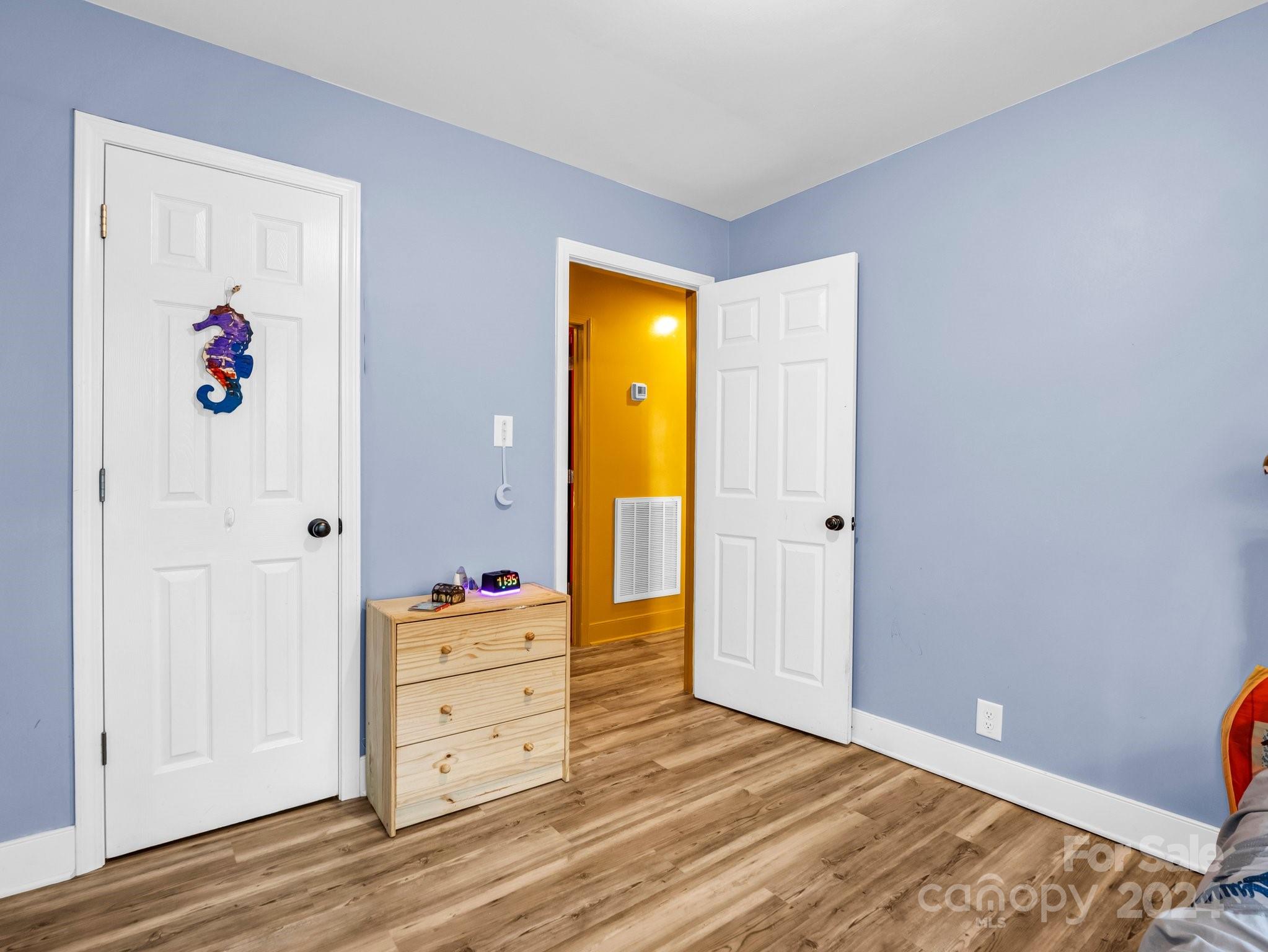 1251 Howards Creek Mill Road Vale, NC 28168 - Photo 18 of 30 a view of a bedroom with wooden floor and closet