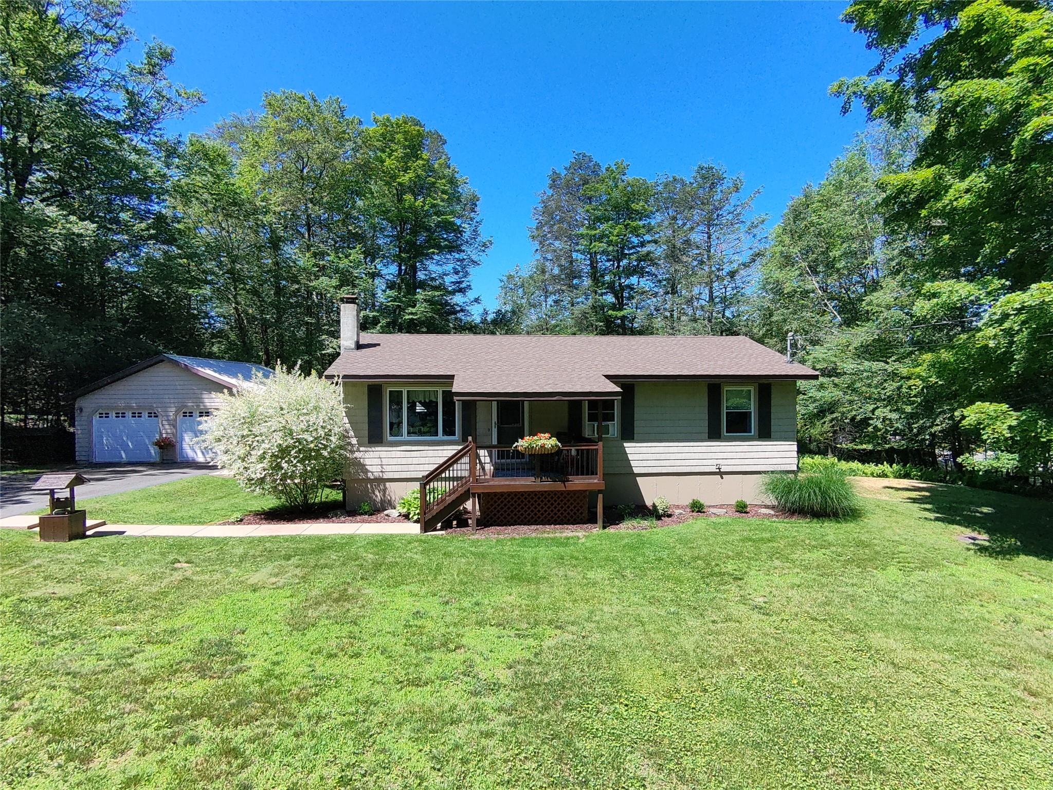 497 Myers Road Neversink, NY 12765 - Photo 1 of 1 Single story home featuring a front lawn, a detached garage, a chimney, and a porch