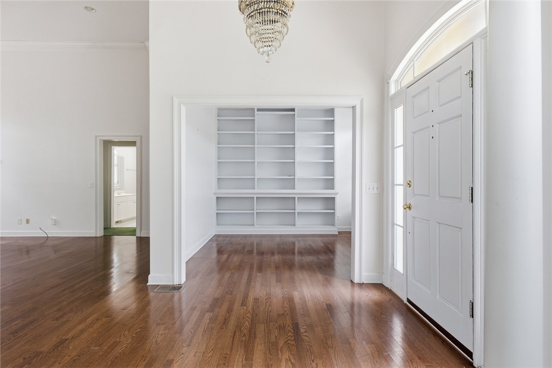 110 Garden Gate Drive Anderson, SC 29621 - Photo 10 of 35 This inviting entrance features rich hardwood floors and elegant built-in shelving, creating a welcoming atmosphere.