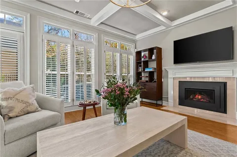 a living room with furniture fireplace and flat screen tv