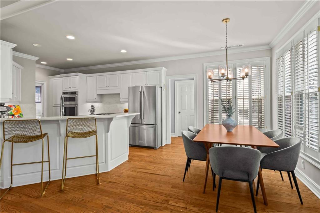 4120 Paran Pointe Drive Northwest Atlanta, GA 30327 - Photo 17 of 47 a kitchen with stainless steel appliances kitchen island granite countertop a table chairs and a refrigerator