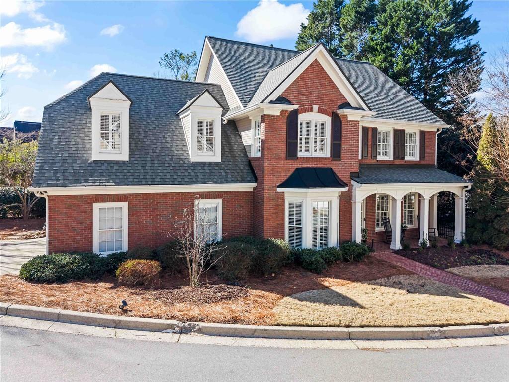 4120 Paran Pointe Drive Northwest Atlanta, GA 30327 - Photo 2 of 47 a front view of a house with a yard and garage