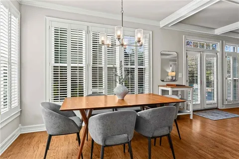 a dining room with furniture and wooden floor