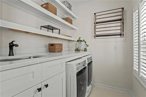 a kitchen with a sink a stove and cabinets