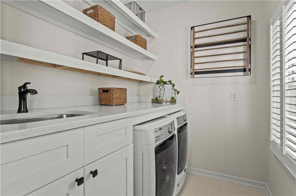 4120 Paran Pointe Drive Northwest Atlanta, GA 30327 - Photo 27 of 47 a kitchen with a sink a stove and cabinets