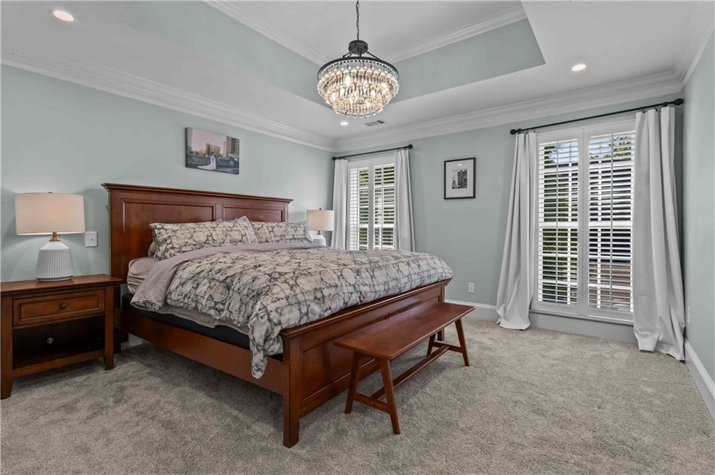 4120 Paran Pointe Drive Northwest Atlanta, GA 30327 - Photo 28 of 47 a bed sitting in a bedroom next to a window and a chandelier