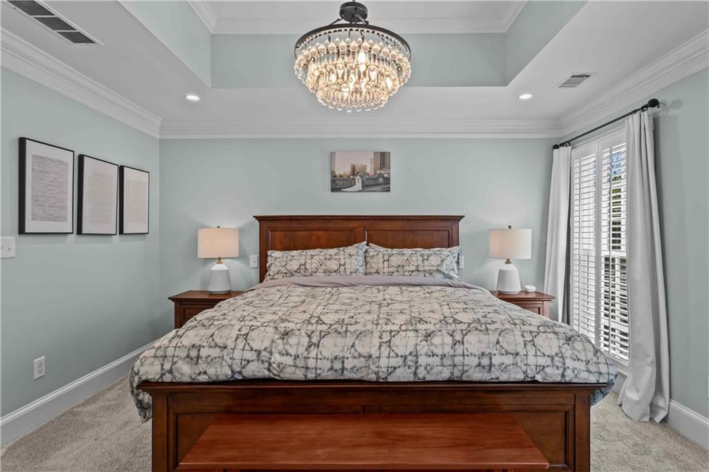 4120 Paran Pointe Drive Northwest Atlanta, GA 30327 - Photo 29 of 47 a bedroom with a large bed and a chandelier