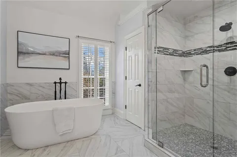 a bathroom with a bathtub and shower