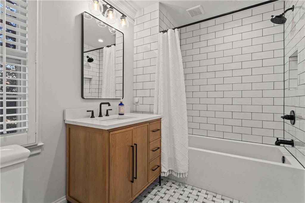 4120 Paran Pointe Drive Northwest Atlanta, GA 30327 - Photo 37 of 47 a bathroom with a sink a toilet a mirror a bathtub and shower