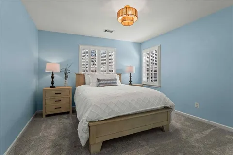 a spacious bedroom with a bed and a window