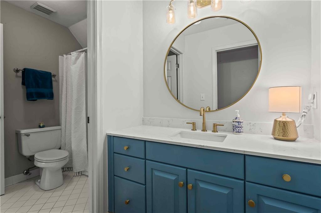4120 Paran Pointe Drive Northwest Atlanta, GA 30327 - Photo 41 of 47 a bathroom with a toilet sink and mirror