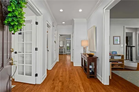 a view of a hallway with wooden floor and staircase