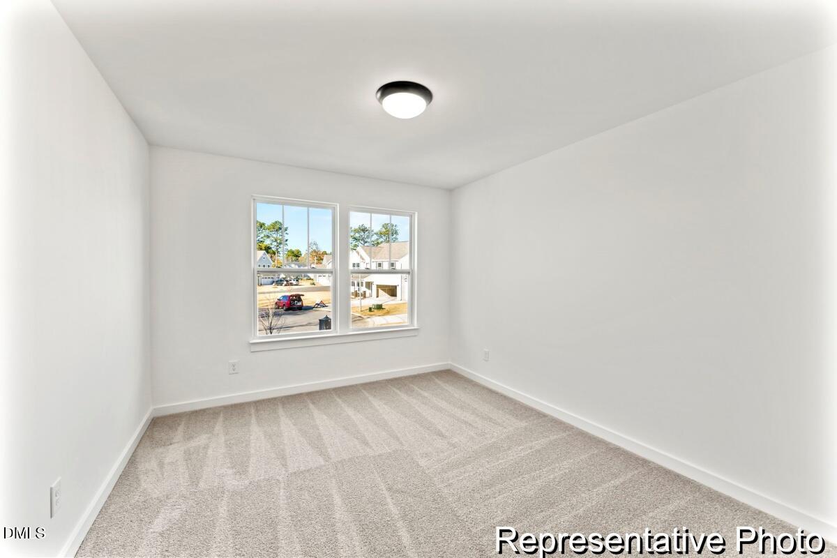 105 Cedarbranch Way, Unit 183P Dunn, NC 28334 - Photo 17 of 24 an empty room with windows