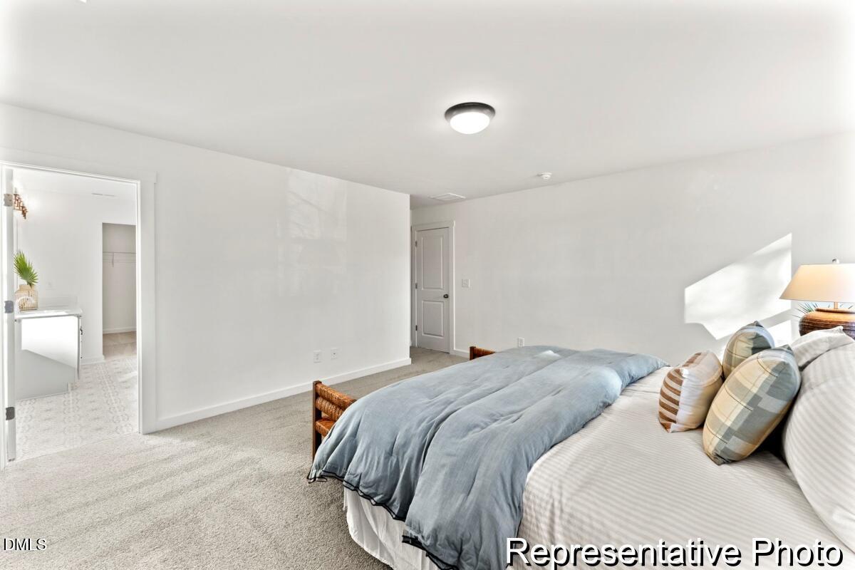 105 Cedarbranch Way, Unit 183P Dunn, NC 28334 - Photo 21 of 24 a bedroom with a bed and a couch