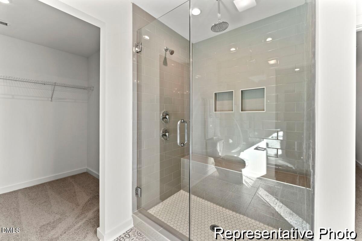105 Cedarbranch Way, Unit 183P Dunn, NC 28334 - Photo 24 of 24 a bathroom with a glass shower door and a bathroom