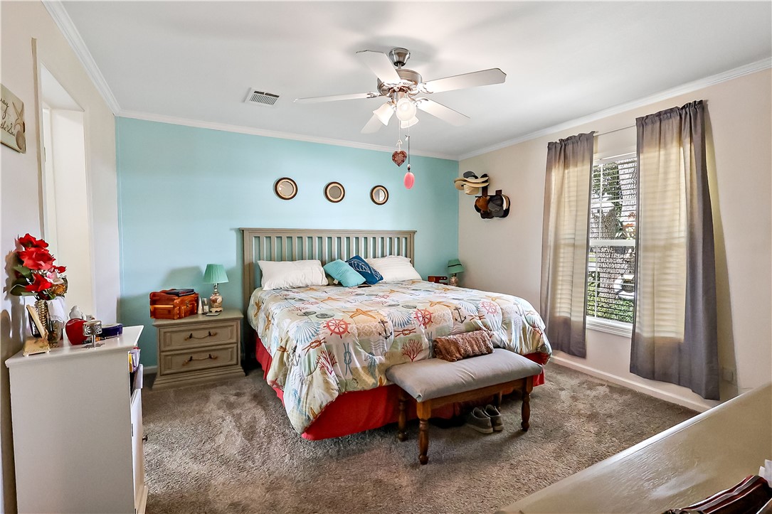 324 Valencia Street Sebastian, FL 32958 - Photo 12 of 21 a bed sitting in a bedroom next to a window