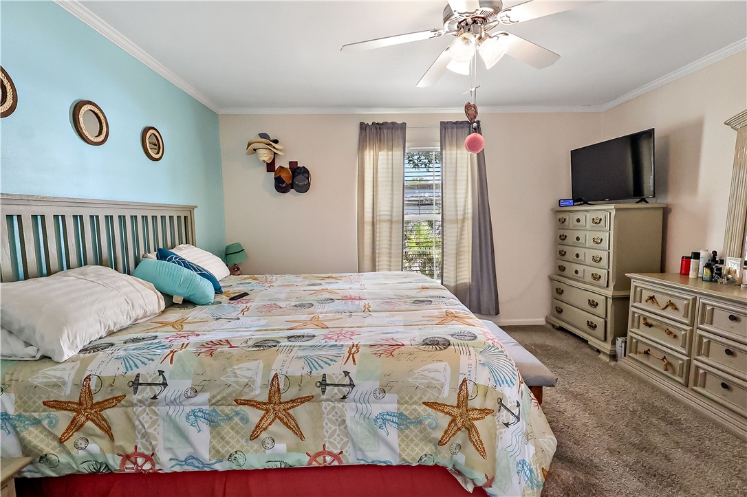 324 Valencia Street Sebastian, FL 32958 - Photo 13 of 21 a bedroom with a bed and a flat tv screen on dresser