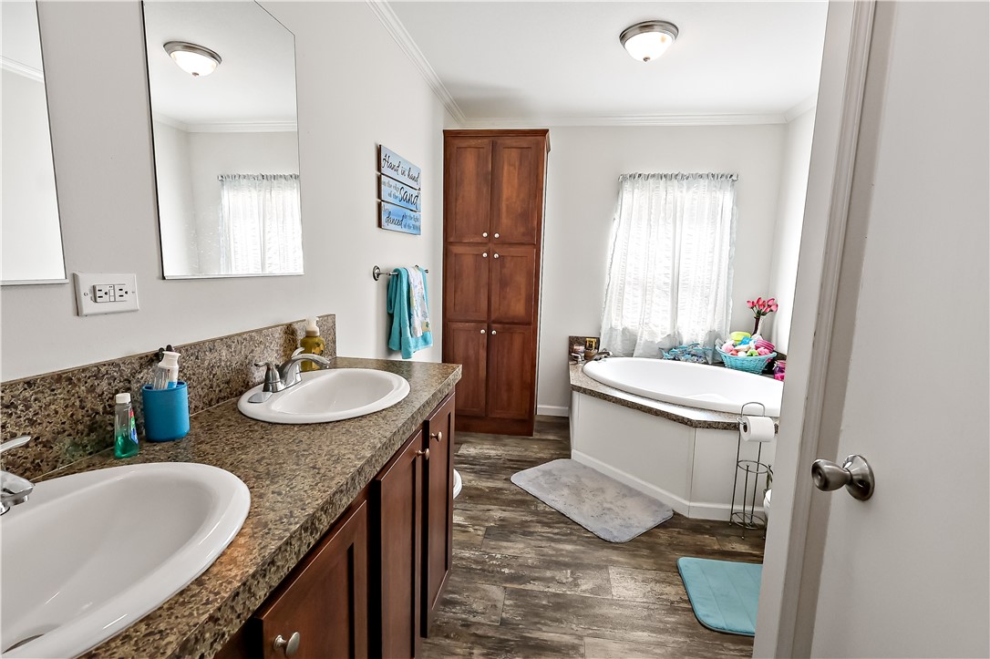 324 Valencia Street Sebastian, FL 32958 - Photo 14 of 21 a bathroom with a granite countertop sink and a mirror