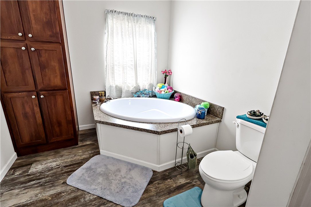 324 Valencia Street Sebastian, FL 32958 - Photo 15 of 21 a white toilet sitting next to a bathroom sink and a vanity