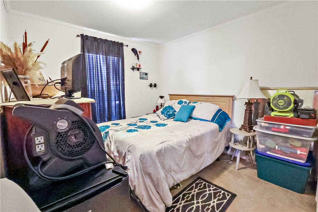 324 Valencia Street Sebastian, FL 32958 - Photo 17 of 21 a bedroom with a bed and a chandelier