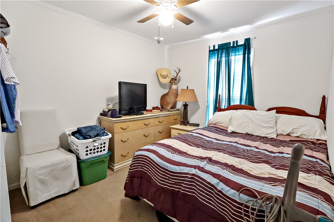 324 Valencia Street Sebastian, FL 32958 - Photo 18 of 21 a bedroom with two beds and a chandelier