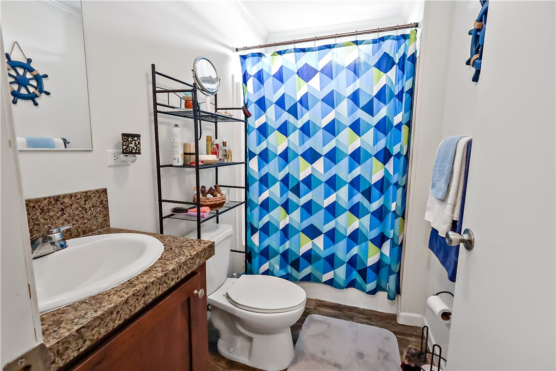 324 Valencia Street Sebastian, FL 32958 - Photo 19 of 21 a bathroom with a granite countertop toilet sink and mirror