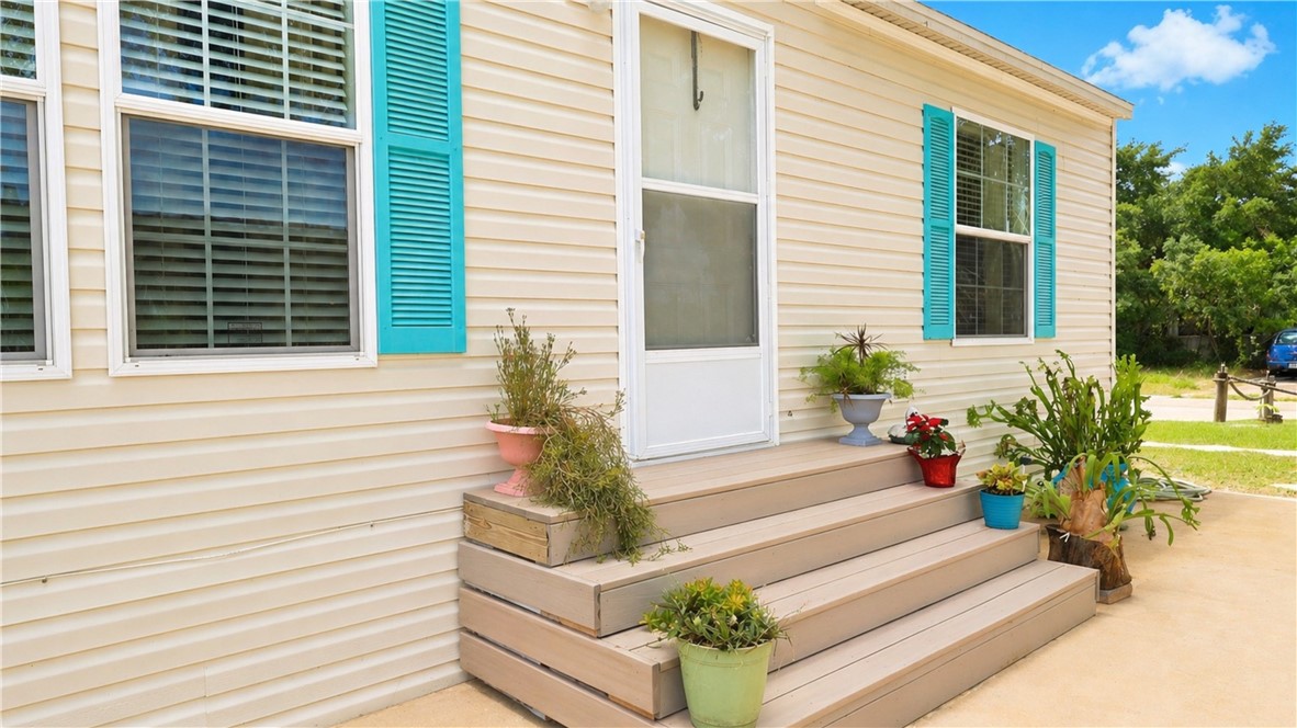 324 Valencia Street Sebastian, FL 32958 - Photo 3 of 21 a potted plant sitting in front of a house