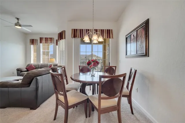 a view of a dining room with furniture and window