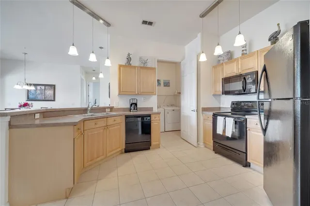 a large kitchen with cabinets and stainless steel appliances