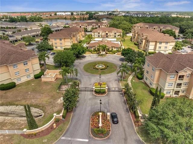 an aerial view of a house with garden space and street view